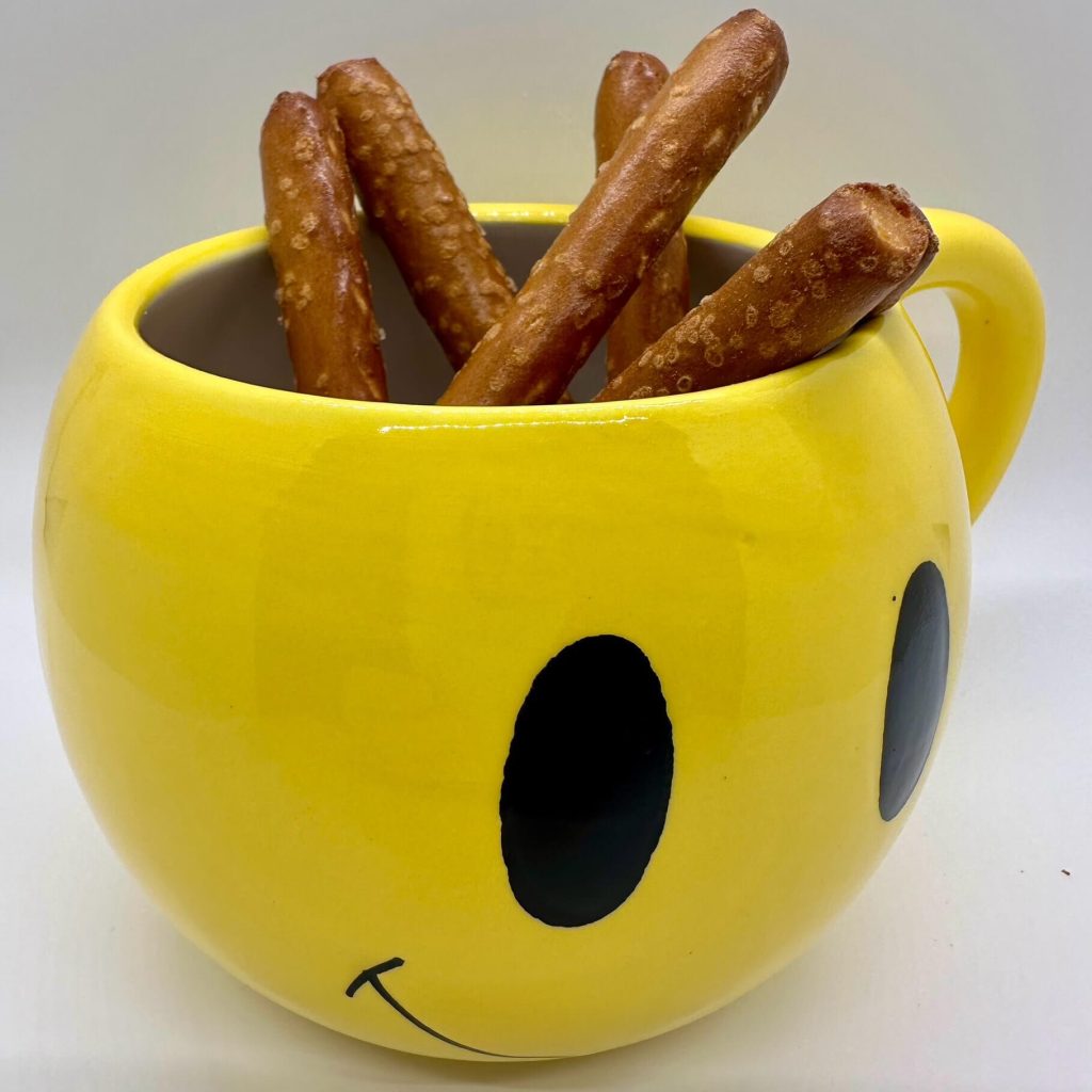 yellow mug with pretzel sticks