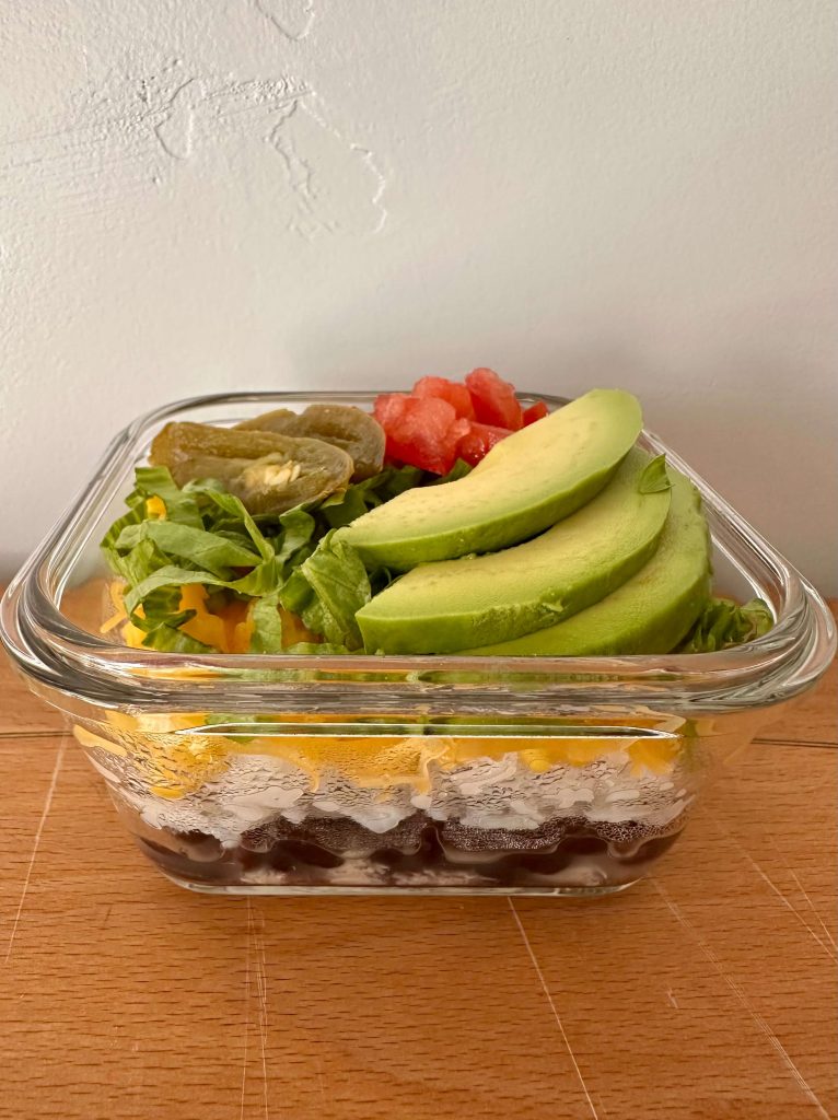 Mexican salad bowl with shredded chicken and avocado