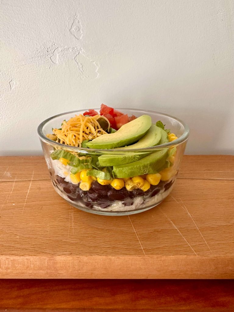 Mexican salad bowl with shredded chicken and avocado